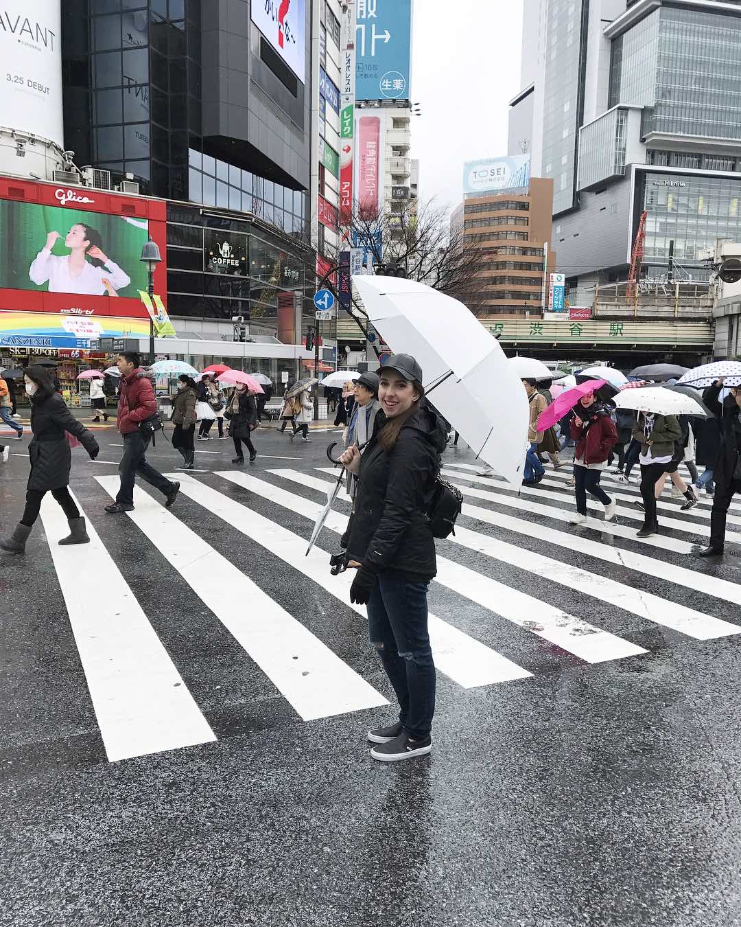travel blogger in shibuya crossing in tokyo japan